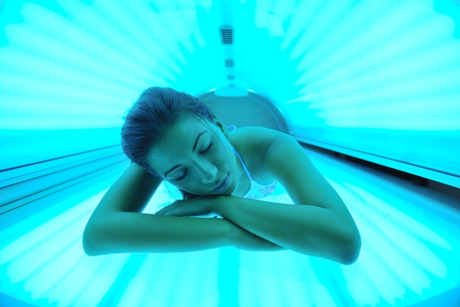 young woman tanning in solarium - using sunbed